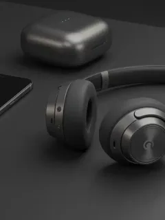 Latest wireless headphones with noise cancellation on modern desk