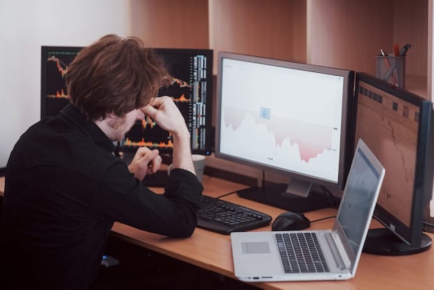 An image showing a small business owner looking concerned at their computer screen, ransomware warning displayed. Graph overlay suggesting financial loss.