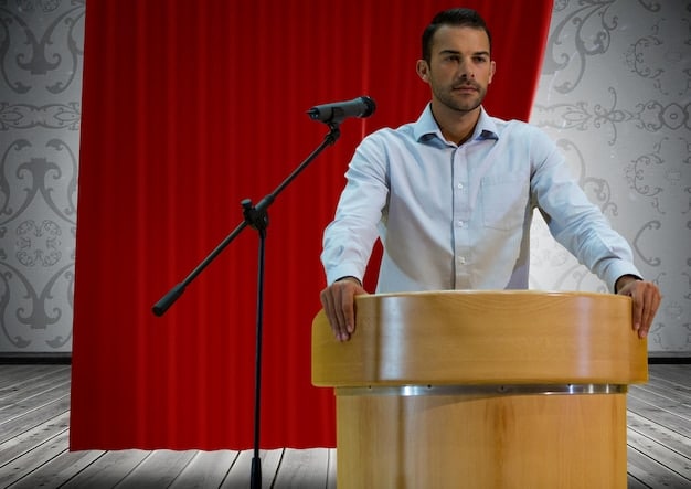 A person at a podium, speaking calmly and confidently to a crowd. Text overlay reads: 