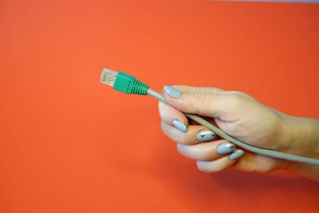 A hand pulling the Ethernet cable out of a computer tower, symbolizing the immediate disconnection from the internet. The background is a simple workspace, emphasizing the focus on the action.